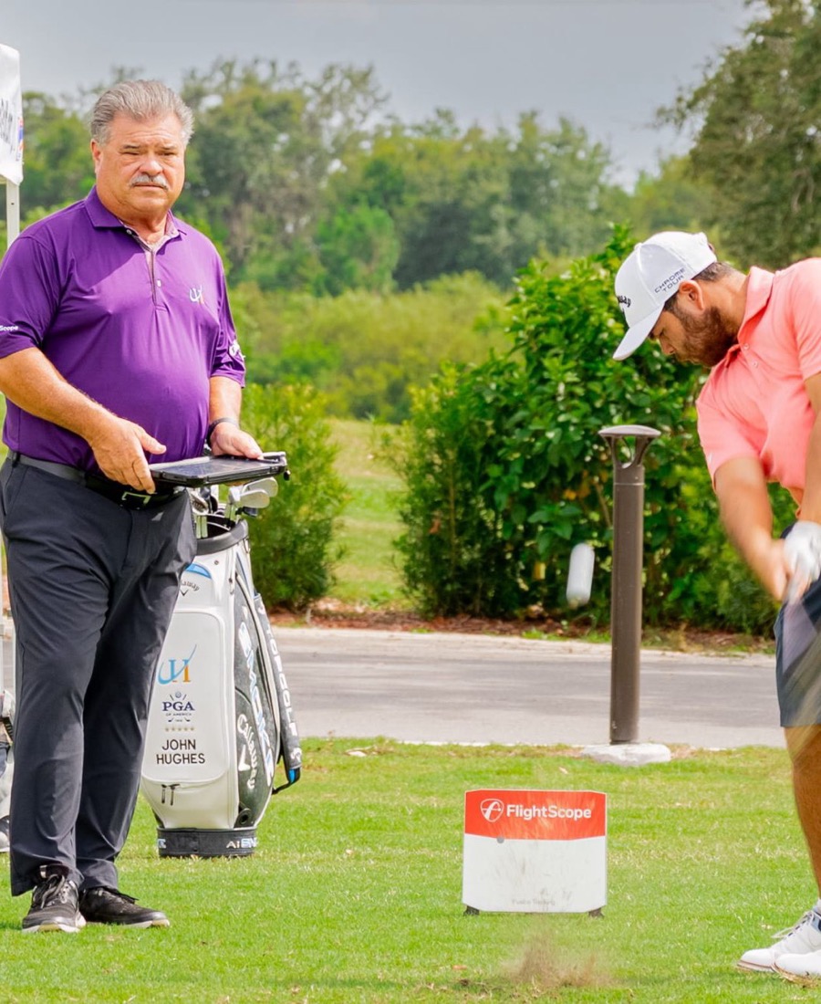 John Hughes reviewing launch monitor numbers with a client